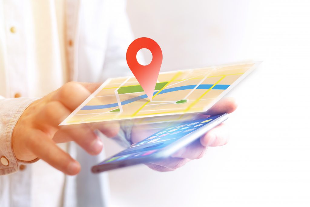 Vuiew of a Concept of geographical localization on a map with a smartphone